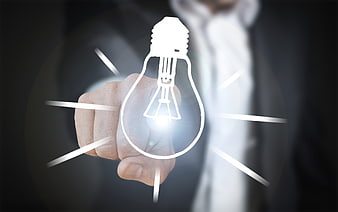 Businessman touching glowing lightbulb icon for innovation concept