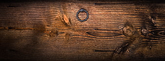Close-up of rustic wooden door with iron ring handle