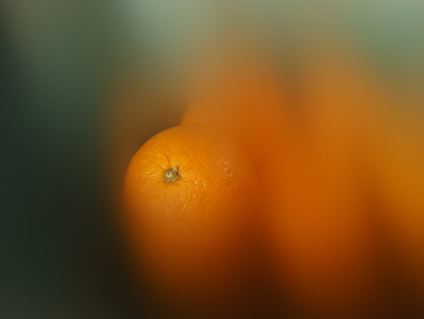 Close-up of a single orange with blurred background