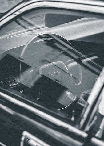 Black and white close-up of vintage car steering wheel