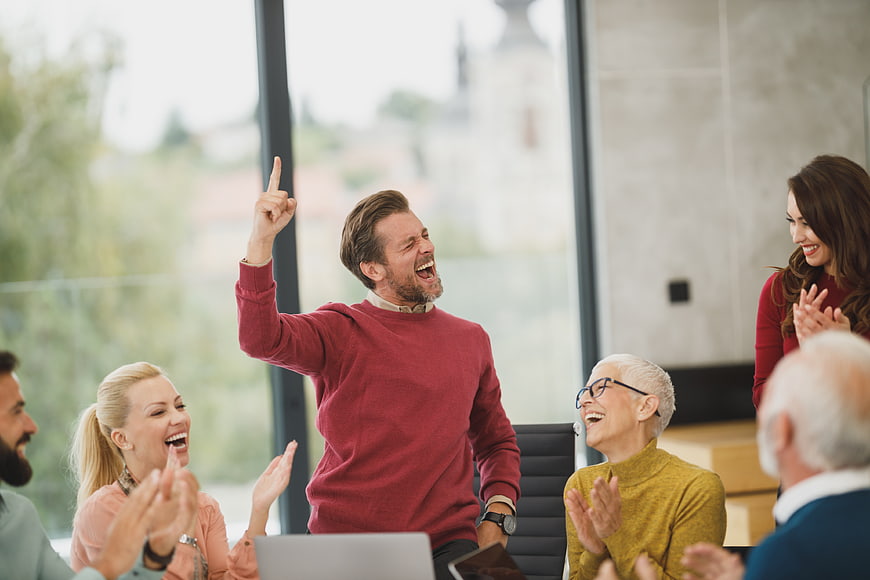 Happy Diverse Team Celebrating Success in Modern Office