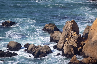 Rugged coastal rocks with crashing ocean waves