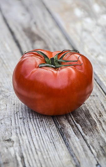 Fresh Red Heirloom Tomato on Rustic Wooden Background