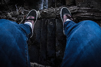 First Person View of Sneakers on Wooden Log