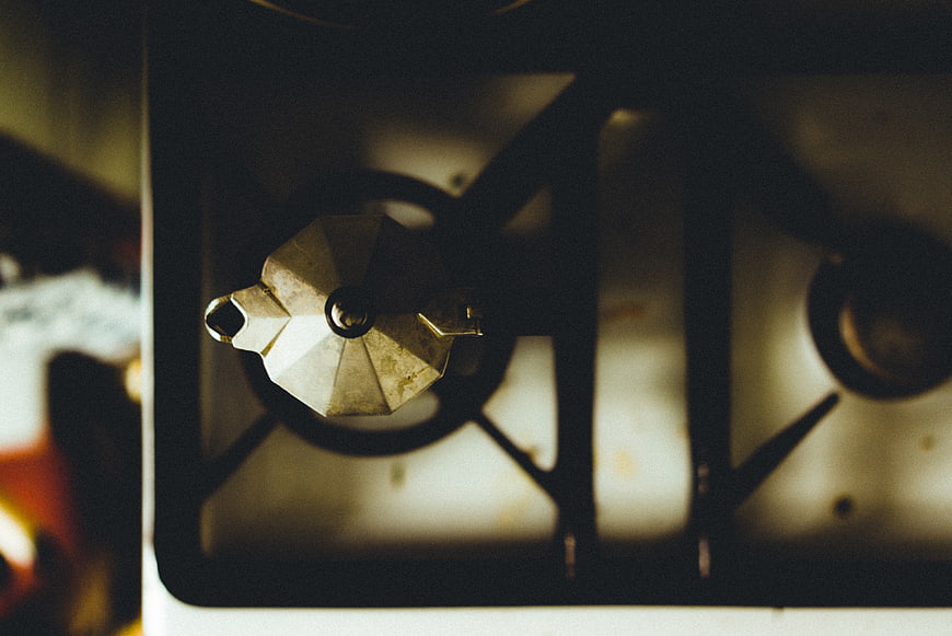 Vintage Moka Pot on Gas Stove Top Down View