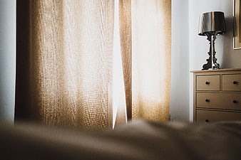 Cozy Bedroom Interior with Beige Curtains and Wooden Dresser