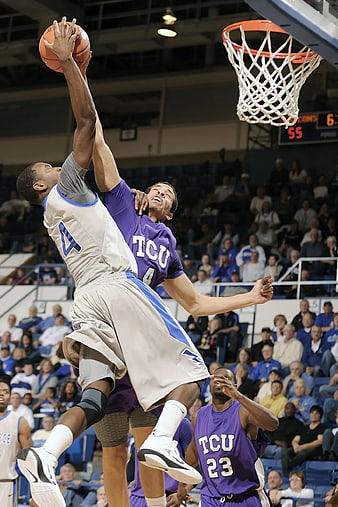 Basketball Player Dunking Over Defender in Action