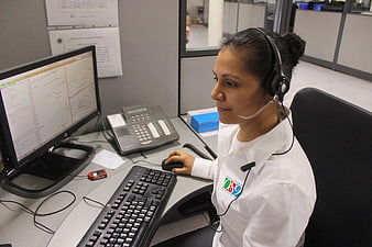 Female Dispatcher Working at Emergency Call Center Desk