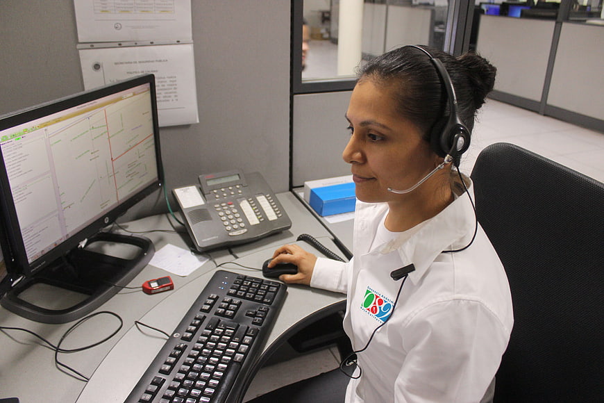 Female Dispatcher Working at Emergency Call Center Desk
