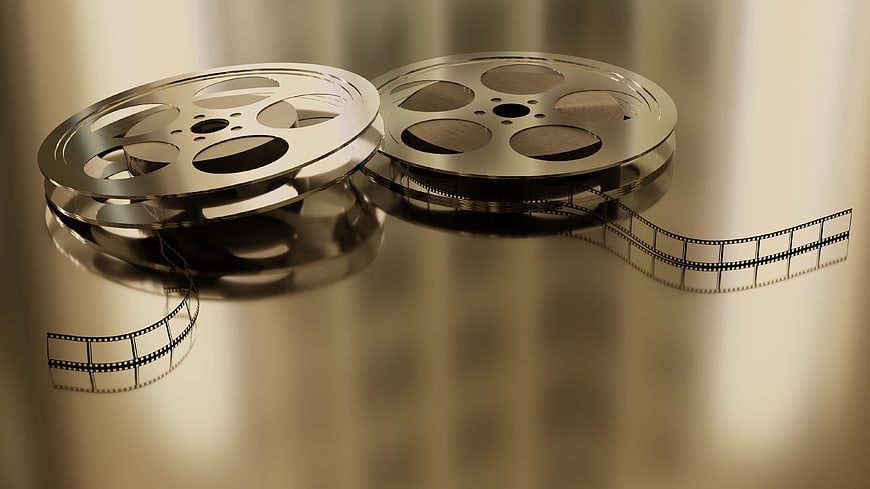 Vintage Film Reels and Strip on Golden Background