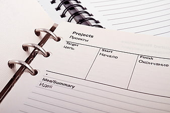 Close-up of bilingual project planning notebook page
