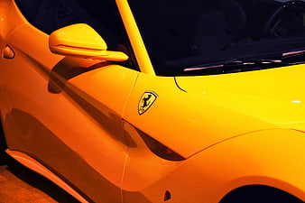 Close-up of Yellow Ferrari Side Emblem and Bodywork
