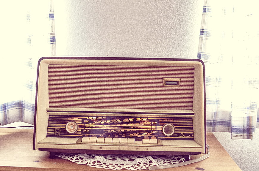 Vintage Philips tube radio on wooden table with lace doily