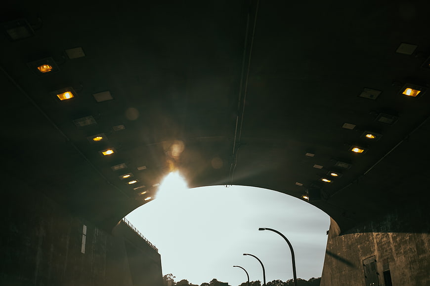 View from Under a Concrete Overpass Tunnel with Street Lights