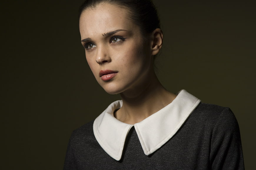 Studio Portrait Of Young Woman With White Collar