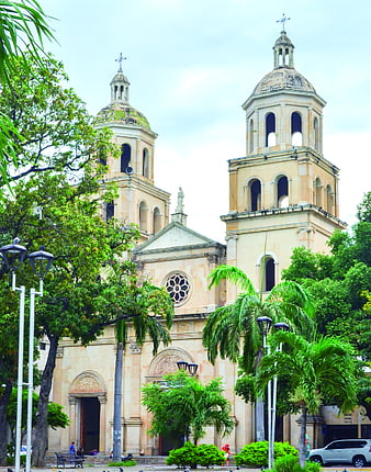 Historic Cathedral with Twin Towers and Palm Trees