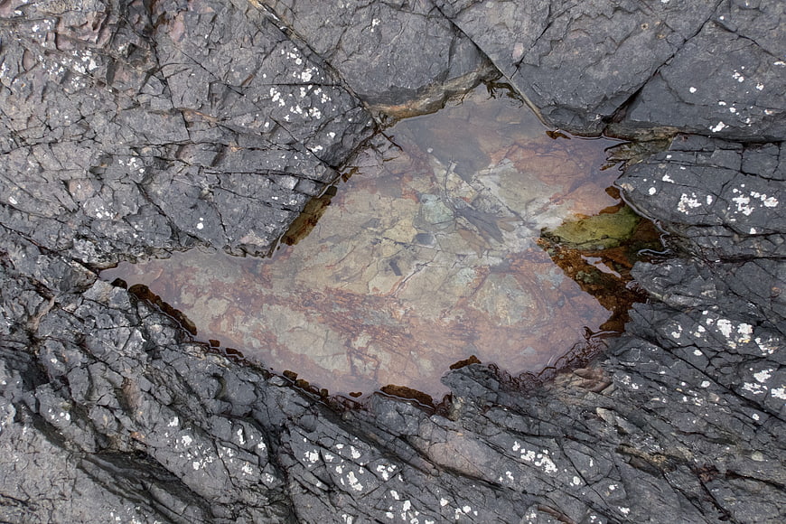 Top-down view of tide pool in rocky coastal landscape