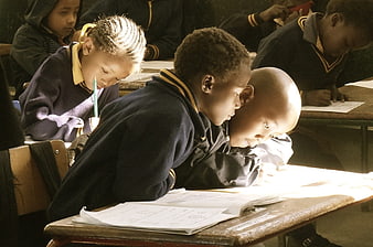 African school children studying intently in a classroom