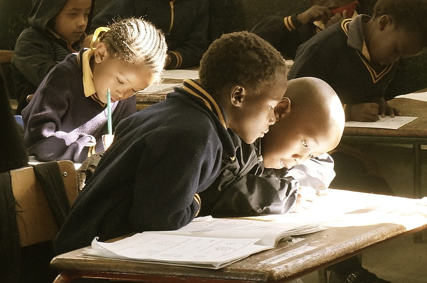 African school children studying intently in a classroom