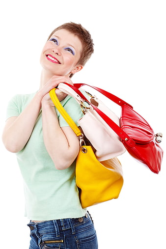 Happy woman holding colorful handbags against white background