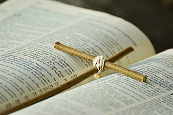 Wooden Cross on Open Bible Pages