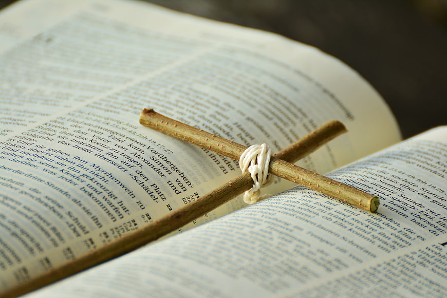 Wooden Cross on Open Bible Pages