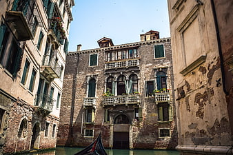 Venetian canal with historic buildings and gondola bow