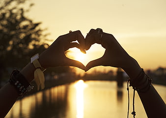 Silhouette of Hands Making Heart Shape at Sunset