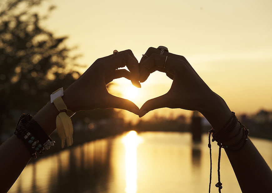 Silhouette of Hands Making Heart Shape at Sunset