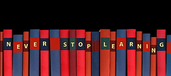 Books spelling never stop learning on black background