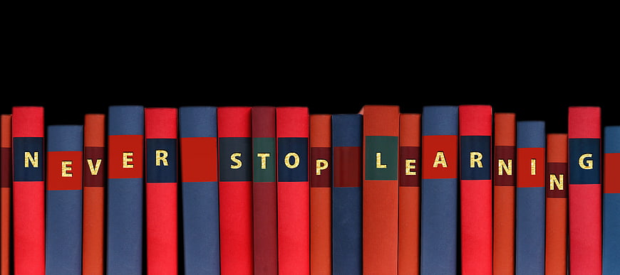 Books spelling never stop learning on black background
