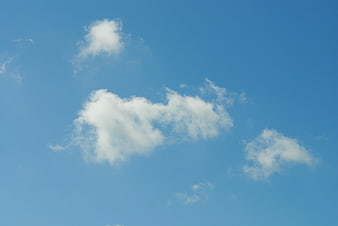 White clouds floating in a clear blue summer sky
