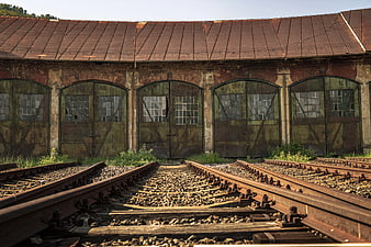 Rusty Railroad Tracks Leading to Abandoned Train Roundhouse