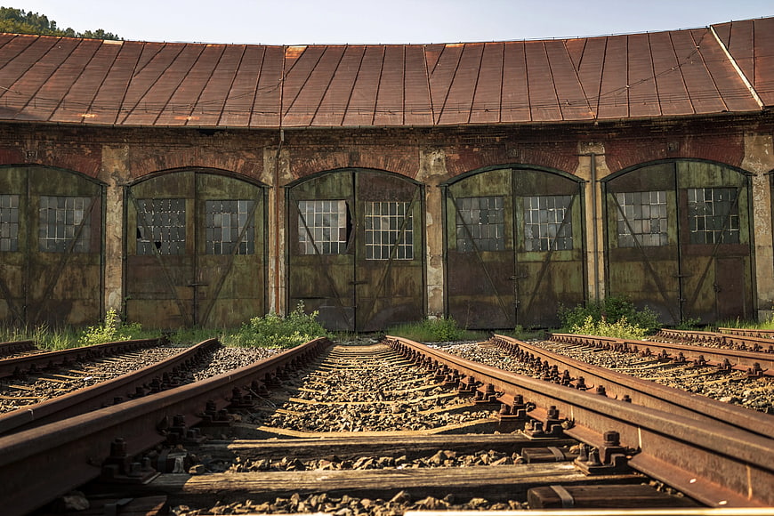 Rusty Railroad Tracks Leading to Abandoned Train Roundhouse