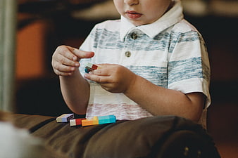 Toddler boy playing with colorful wooden blocks