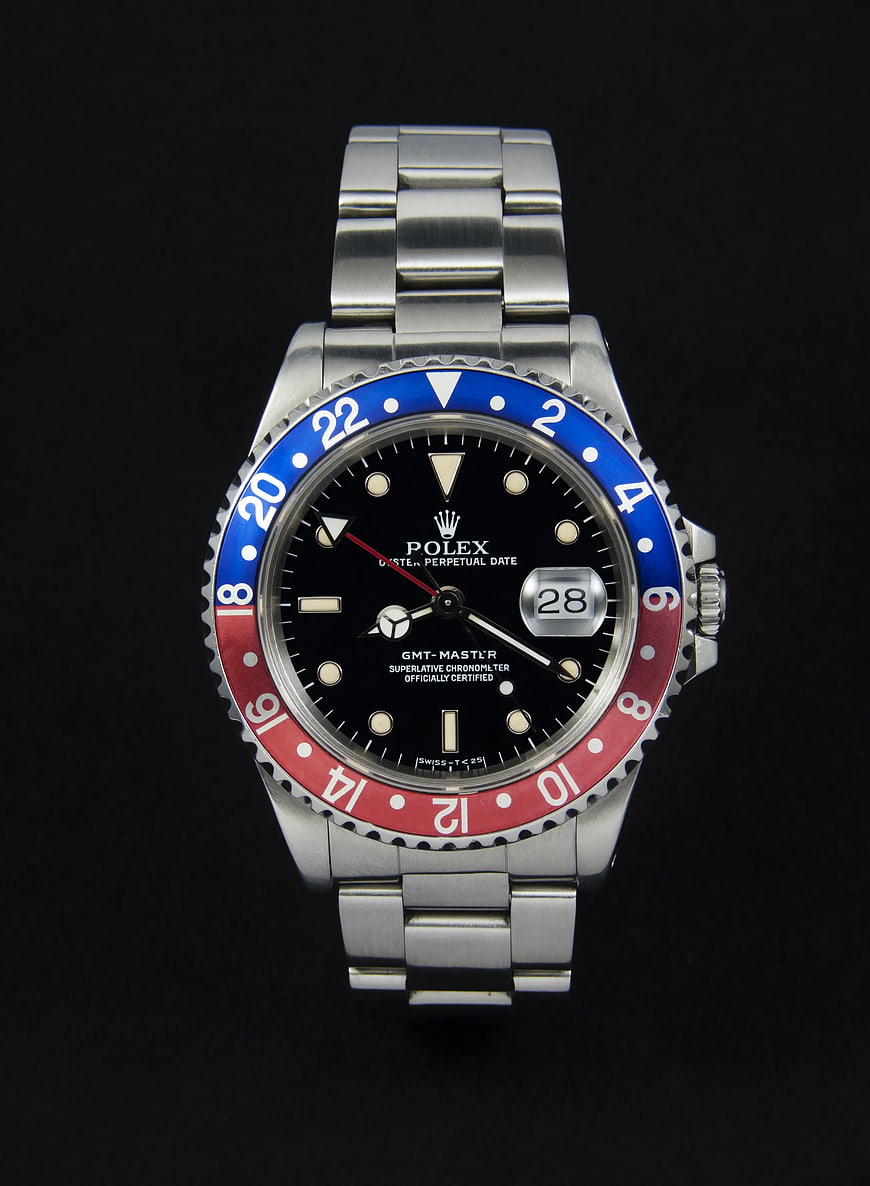 Silver Rolex GMT-Master II Pepsi Watch on Black Background