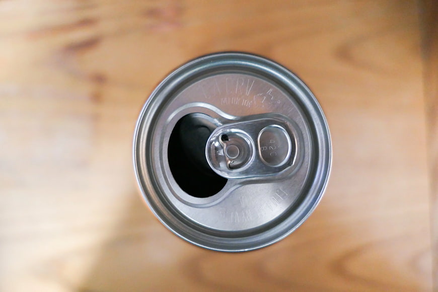 Top View of Open Aluminum Beverage Can on Wood