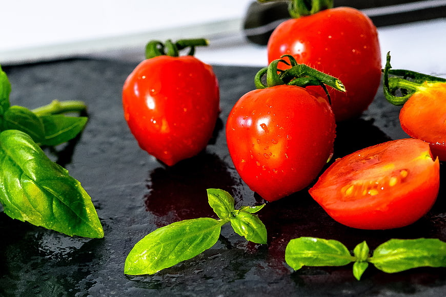 Fresh Red Tomatoes and Basil on Dark Slate