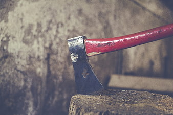 Red Hatchet Embedded in Wood Log