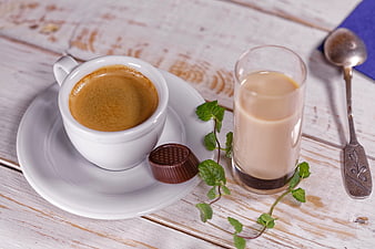 Espresso and milk coffee on rustic white wooden table