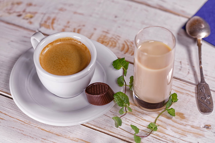 Espresso and milk coffee on rustic white wooden table