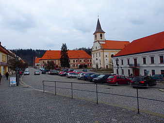 Cobblestone Square with Church and Parked Cars in Namest nad Oslavou