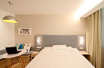 Modern Hotel Bedroom Interior With Gray Headboard And White Linens