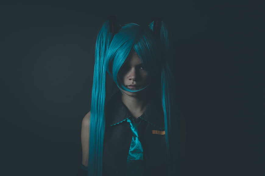 Dark moody Hatsune Miku cosplay portrait with blue twin tails