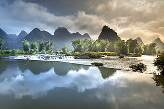 Scenic River Landscape With Karst Mountains And Bamboo In Vietnam
