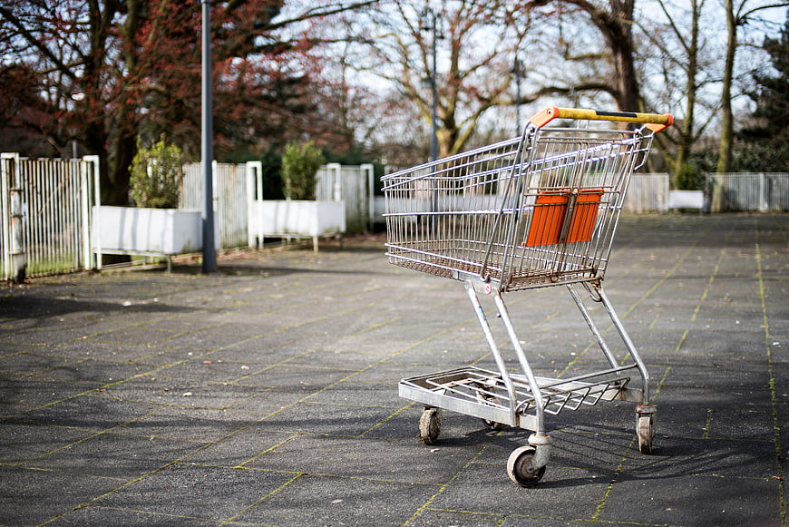 Lonely Shopping Cart in Empty Parking Lot