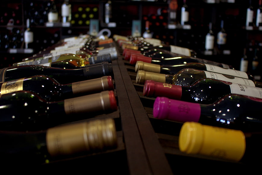 Rows of wine bottles in a cellar rack