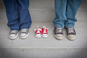 Family sneakers on concrete steps with baby shoes
