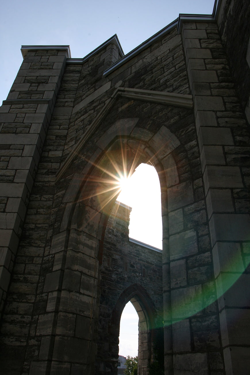 Sunburst Through Stone Arch of Historic Church Ruins