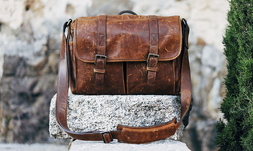 Vintage Brown Leather Messenger Bag on Stone